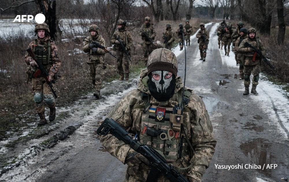 Ukrainian servicemen walk on the road toward their base near the frontline in the Donetsk region.